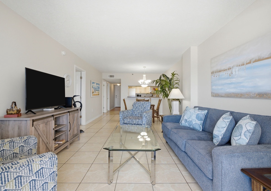 Ocean Breeze E702- Sink into plush seating and unwind in your bright, open living space with coastal-inspired touches and a fully equipped kitchen just steps away.