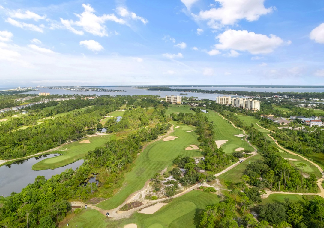 Lost Key Golf An aerial view captures the expansive golf course and surrounding waterfront area where the property is located, offering a scenic backdrop for your stay.