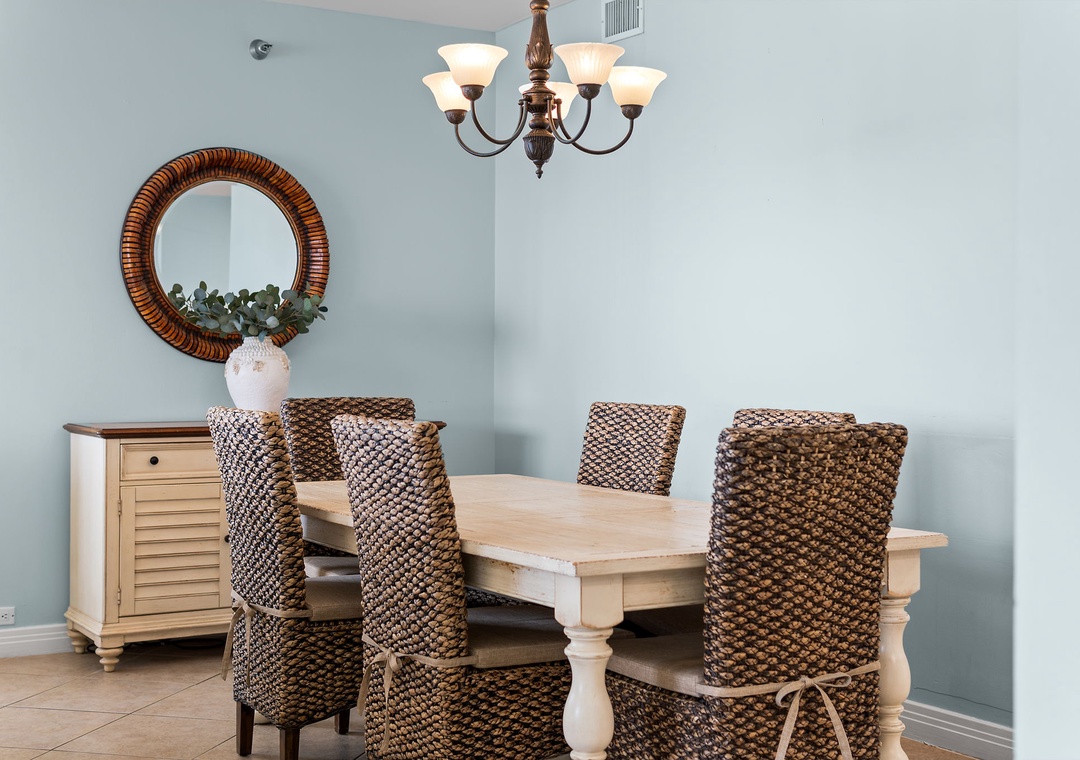 Beach Colony Tower 10C- Gather around this inviting dining space where coastal charm meets comfort. Soft blue walls and woven seating create the perfect setting for your morning coffee or evening meals together.