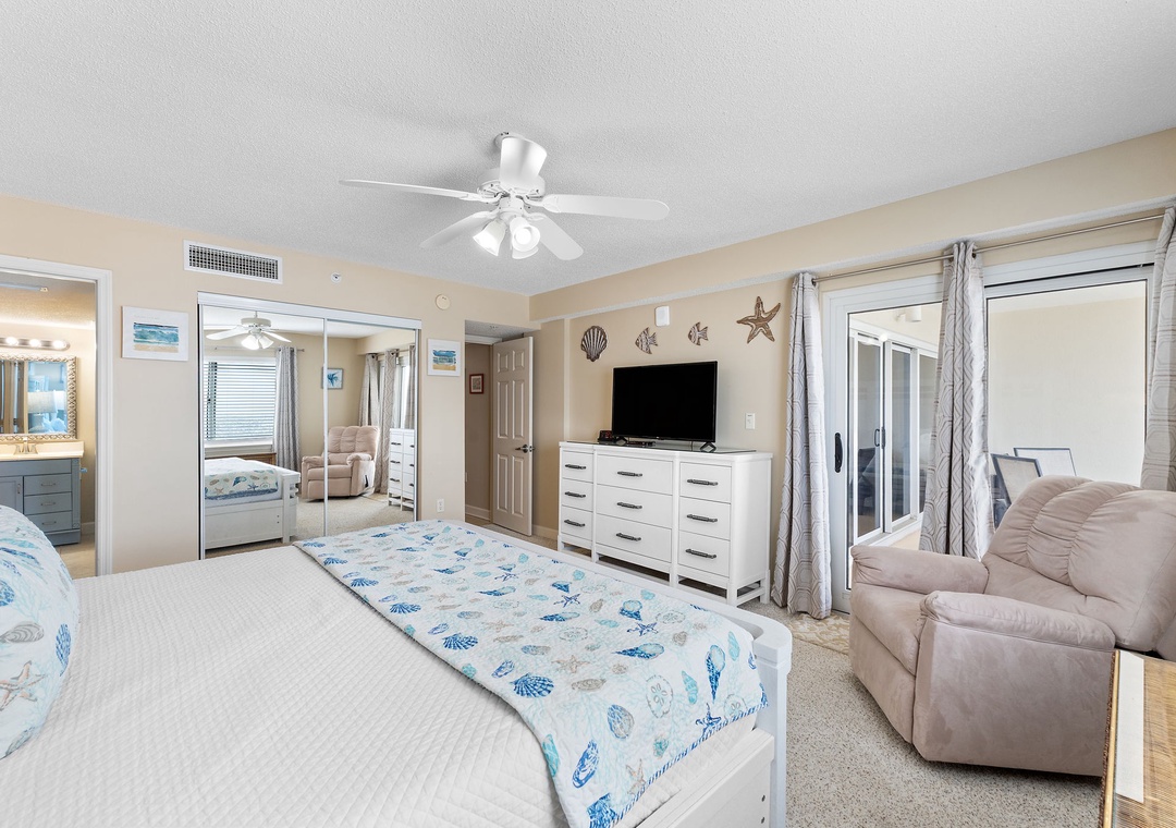 Sandy Key 628- Your coastal-themed bedroom invites relaxation with plush bedding, a comfy recliner, and beachy accents that set a soothing seaside tone for your stay.