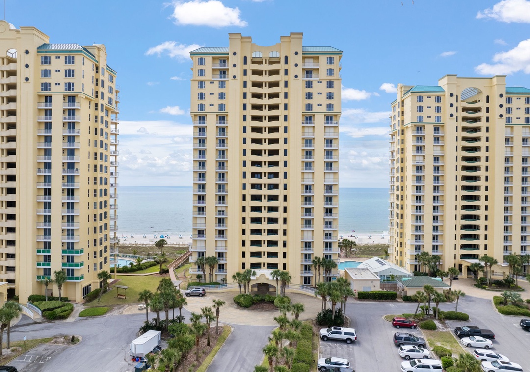 Beach Colony Tower 10C- This beachfront resort complex features high-rise buildings overlooking the sandy shoreline, with lush landscaping and convenient parking for your stay.