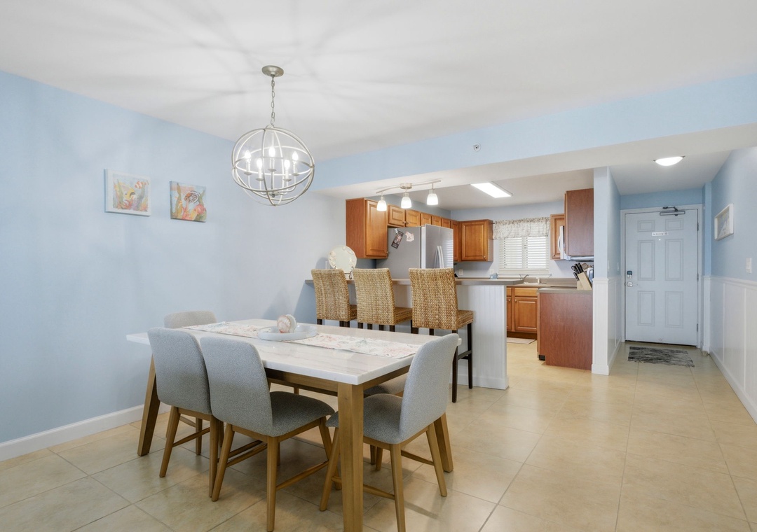 Sandy Key 637- Gather your group around this spacious dining table where memorable meals and laughter come naturally. The open layout flows seamlessly into your fully-equipped kitchen, making hosting effortless.