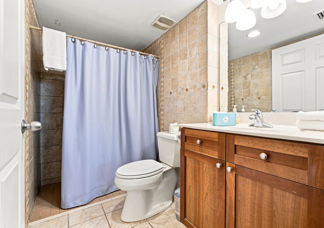 Ocean Breeze W 105- Step into your private bathroom featuring warm tile, a spacious vanity, and a peaceful shower space ready to refresh you after your day's adventures.
