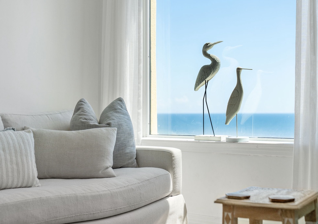 Beach Colony T14B- Settle into plush cushions and let your gaze drift across the serene blue horizon—your perfect spot for unwinding after a day of exploring.