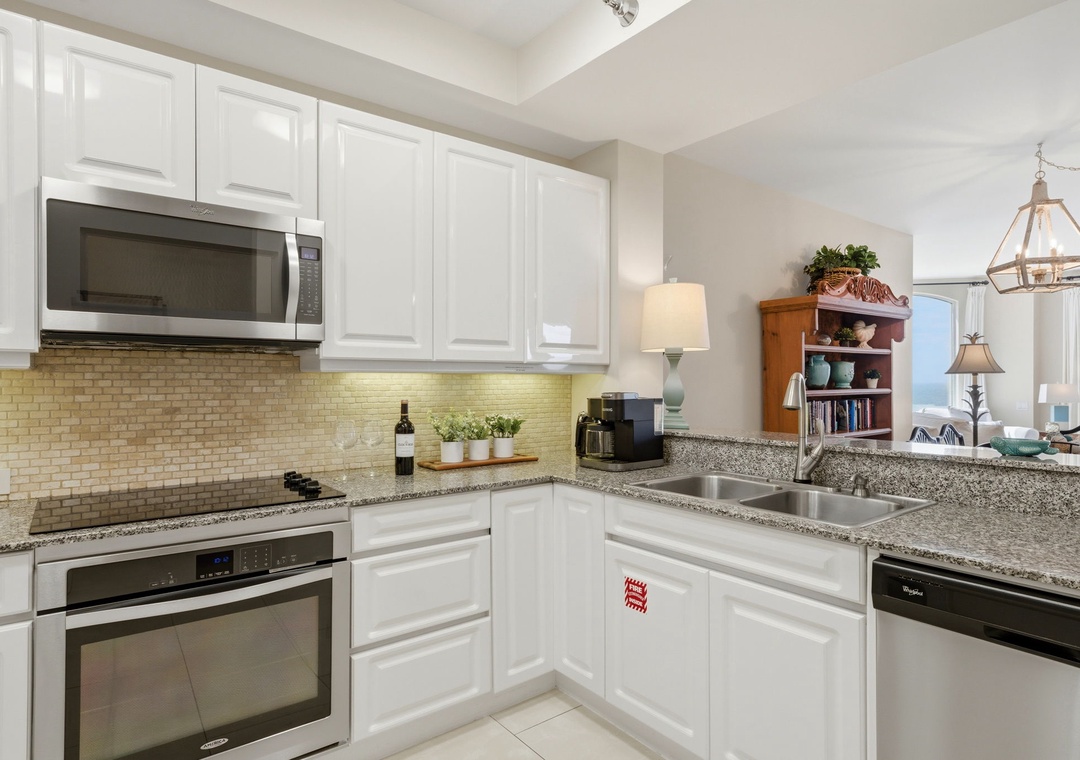 Beach Colony Tower PH1B -Your fully-equipped kitchen features modern stainless steel appliances, granite counters, crisp white cabinetry, and everything you need to prepare delicious home-cooked meals during your stay.