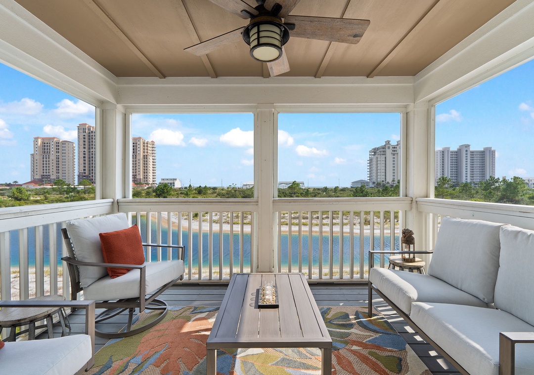 Saltwater & Sunsets- Relax in your screened-in porch with sweeping water views and comfortable seating, perfect for morning coffee or unwinding after a beach day under the gentle breeze of the ceiling fan.