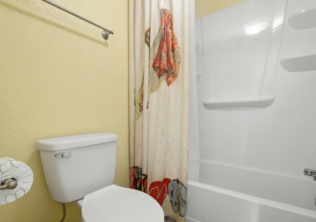 Ocean Breeze E601- Step into your bathroom, complete with a tub-shower combo and cheerful yellow walls that brighten your morning routine.