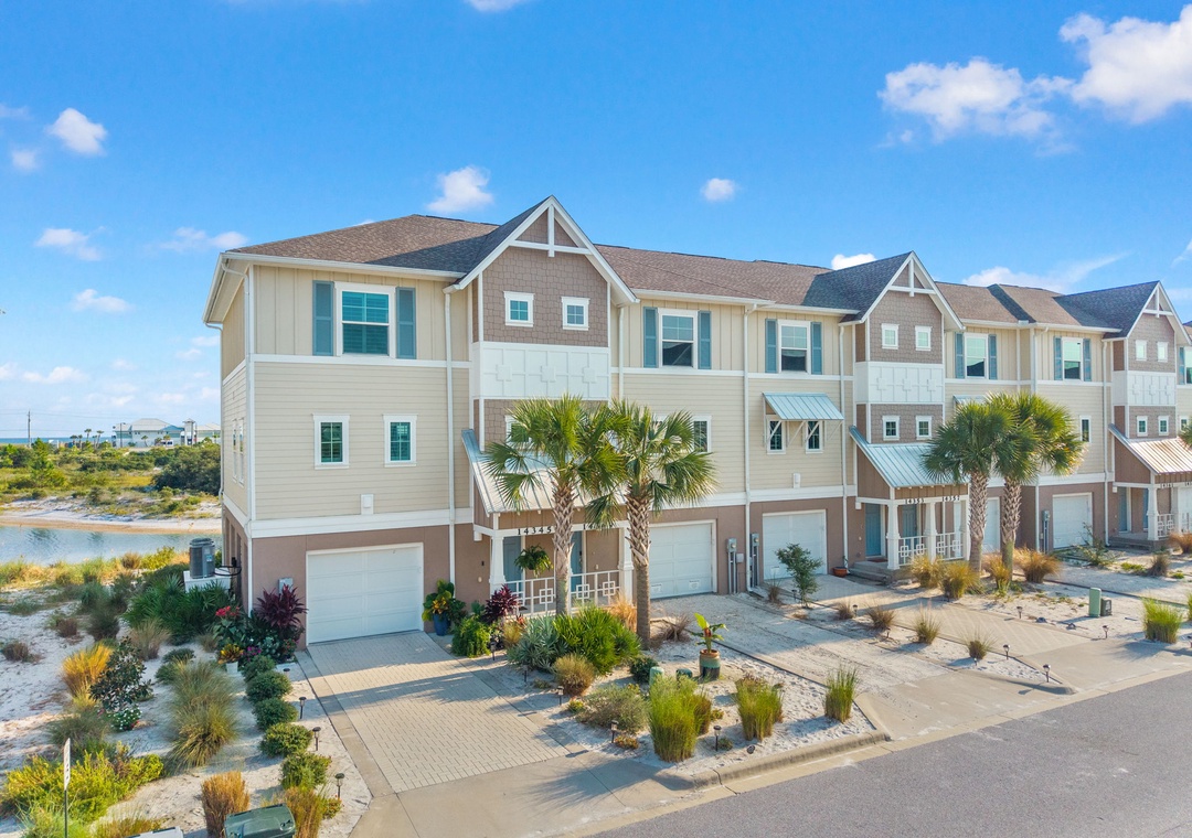 Saltwater & Sunsets- A charming beachside community with palm-lined streets, coastal landscaping, and modern homes just steps from the water's edge, nestled along a peaceful coastal neighborhood.
