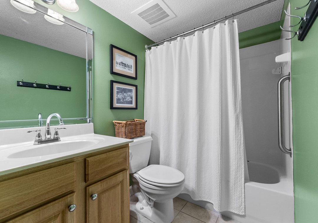 Sandy Key 338- Step into this fresh, inviting bathroom with crisp white fixtures and cheerful green walls. Your own private retreat awaits, complete with a spacious shower and thoughtful touches that make you feel right at home.