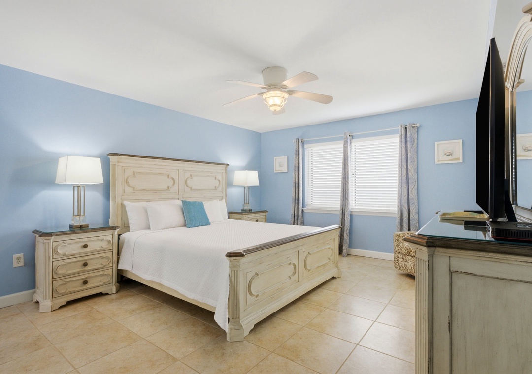 Sandy Key 637- Drift into peaceful sleep in this coastal-inspired bedroom where soft blue walls and whitewashed furniture create your private seaside sanctuary.
