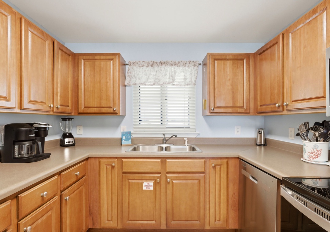 Sandy Key 637- Your fully-equipped kitchen features warm wood cabinetry, plenty of counter space, and all the essentials for preparing meals—from morning coffee to home-cooked dinners during your stay.