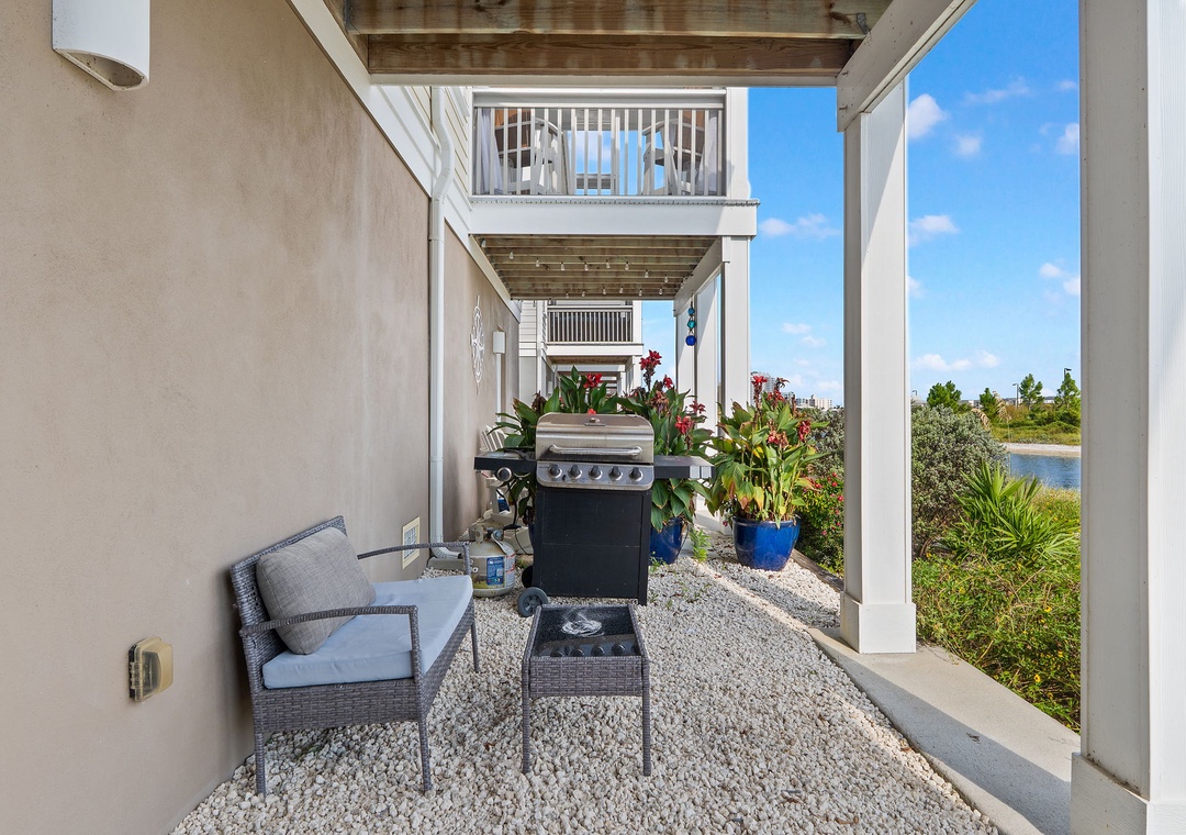 Saltwater & Sunsets- Your own private waterfront oasis awaits! Grill your favorite meal on this sheltered patio while enjoying tranquil lake views and gentle coastal breezes just steps away.