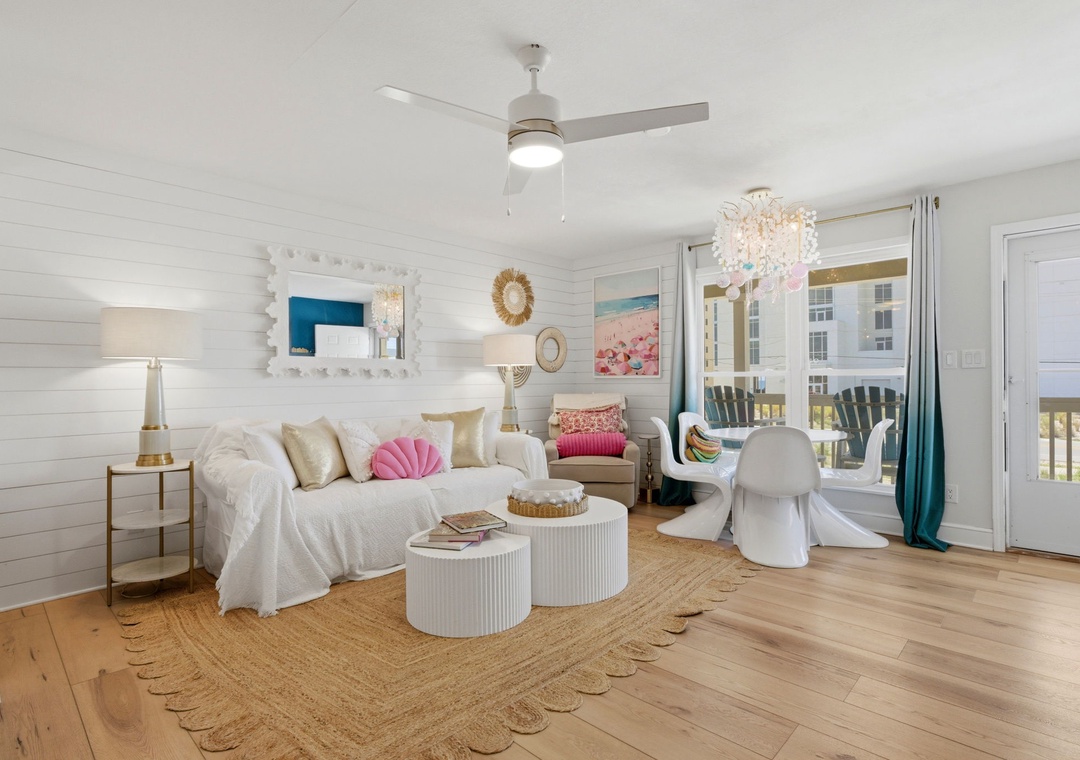 North Lost Key Landing B2- Relax in this bright coastal living room where soft white walls and natural textures create a serene retreat, complete with a charming balcony for your morning coffee.