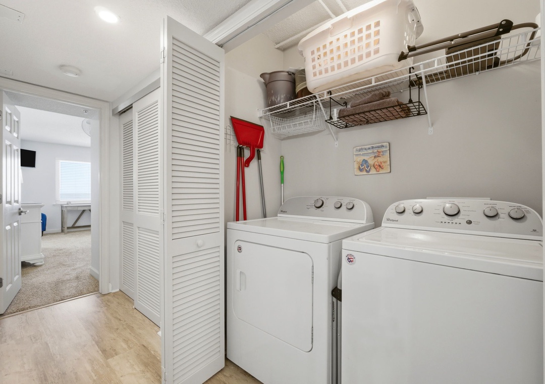 Full-size washer and dryer with shelving for supplies make laundry day easy during your stay.