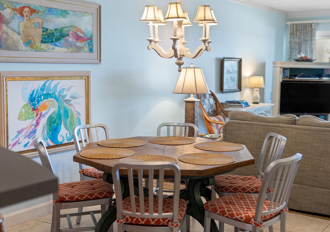 Sandy Key 338- Gather around this beautifully set dining table, where playful coastal art and warm lighting create a welcoming space for your family meals and morning coffee.