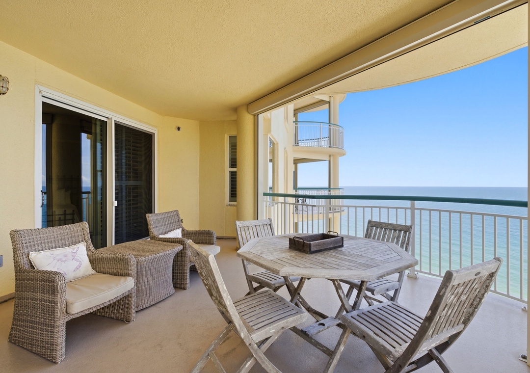 Beach Colony T PH1D- Your private balcony awaits, complete with comfortable seating, a dining table for seaside meals, and stunning ocean views stretching to the horizon—perfect for morning coffee or sunset cocktails.