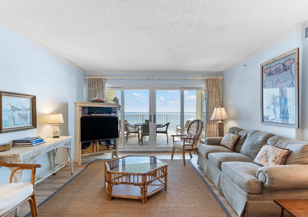 Sandy Key 338- Relax in this coastal living room where your balcony frames endless ocean views. Sink into the sofa, enjoy the soothing palette, and let the sea breeze drift through the open doors.
