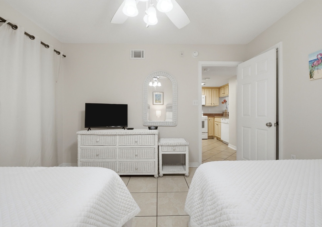 Ocean Breeze E702- Unwind in this bright, airy bedroom with coastal-inspired décor, crisp white linens, and your own TV—perfectly positioned for relaxation after a day of exploring.
