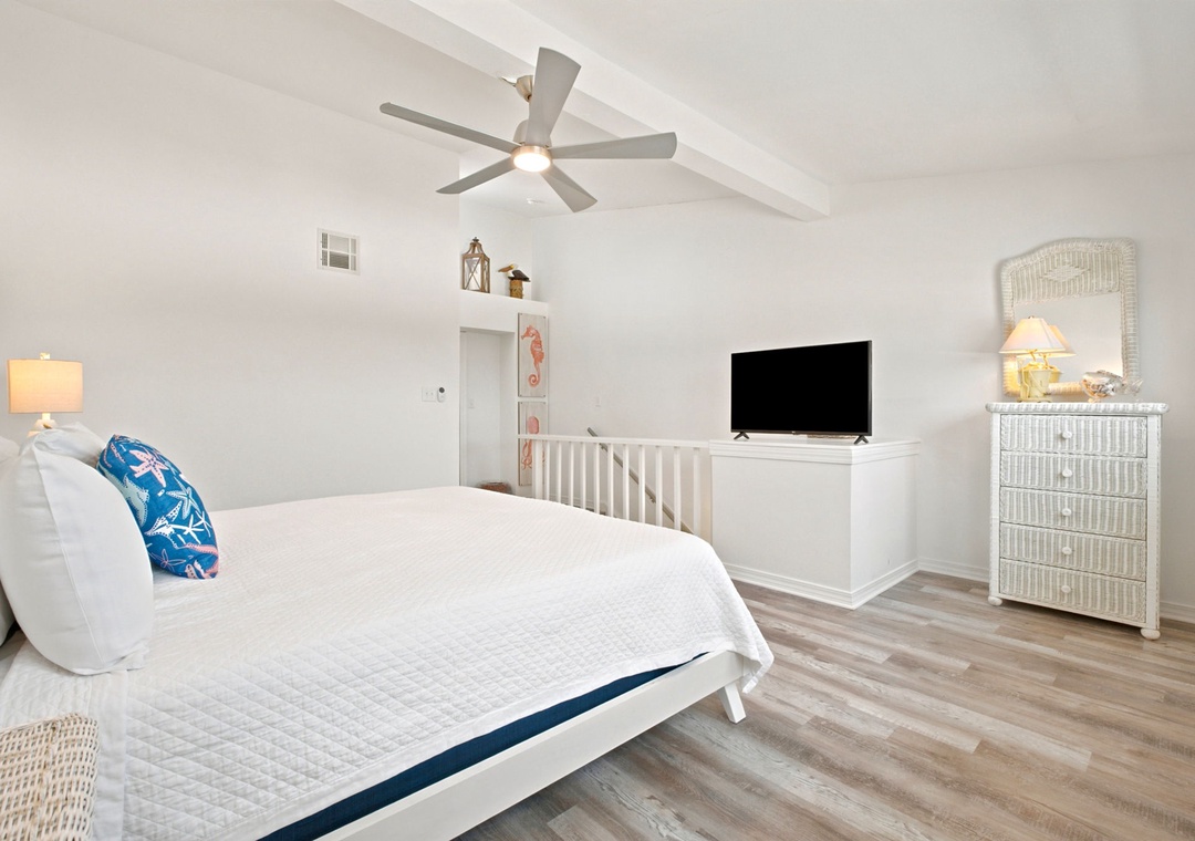 Gulfside Villas 2B- Drift off in this airy bedroom with vaulted ceilings, coastal-inspired décor, and gentle sea-breeze comfort from the overhead fan. Your peaceful retreat awaits.
