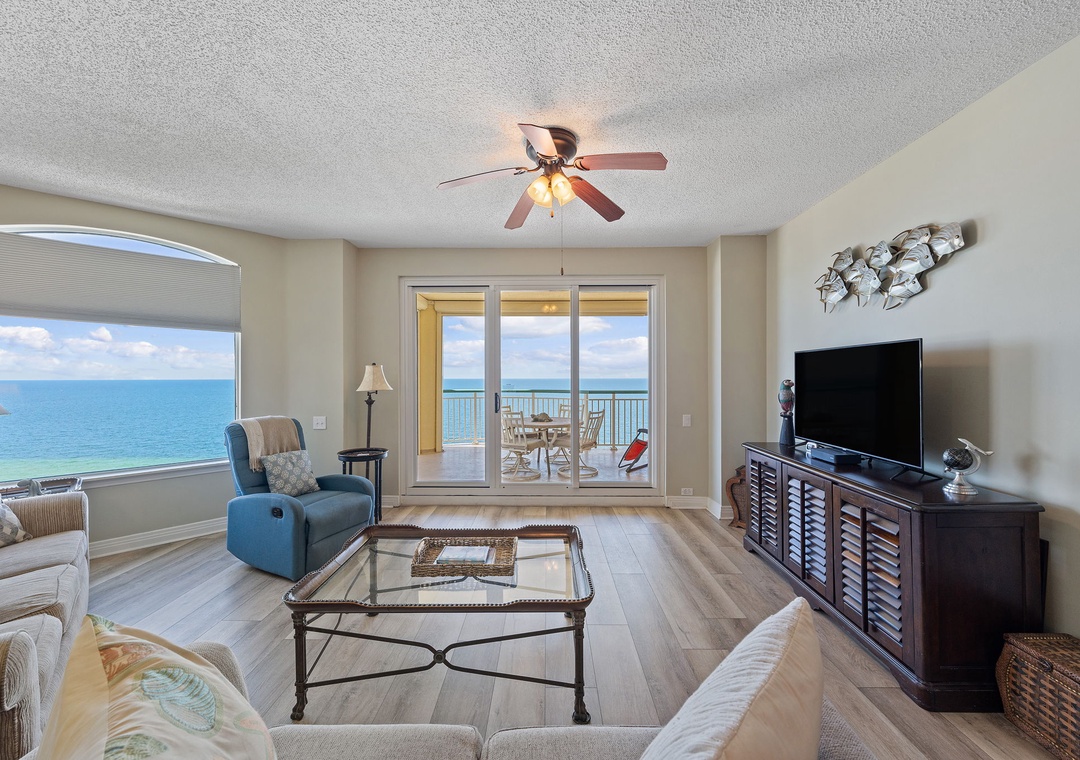 Beach Colony T15B- Relax in your bright, inviting living space with ceiling fan and gorgeous ocean views through floor-to-ceiling glass doors leading to your private balcony. The soothing coastal palette and comfortable seating.