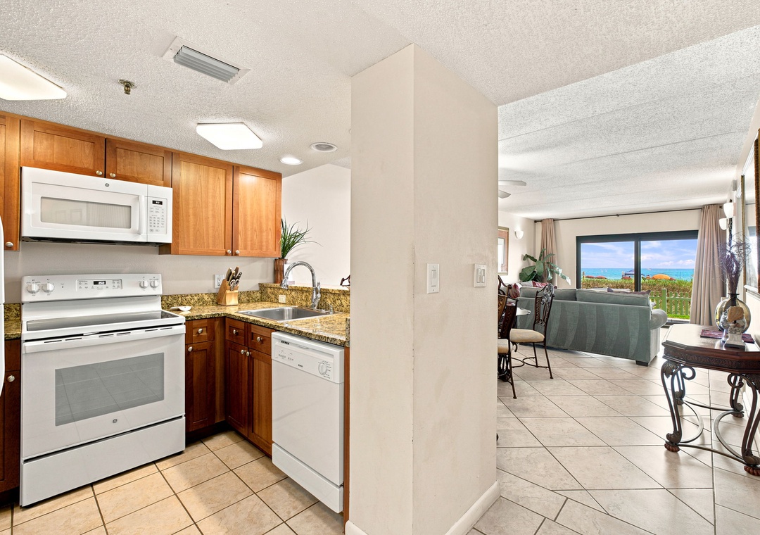Ocean Breeze W 105- Your fully equipped kitchen flows into a bright living space with stunning ocean views just beyond. Warm wood cabinetry and modern appliances make meal prep a breeze while you soak in the coastal backdrop.