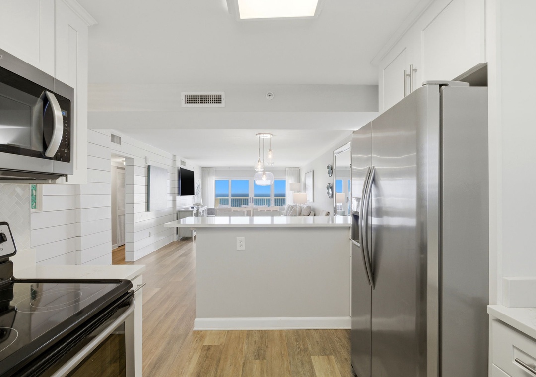 Sandy Key 827- Step into your bright coastal haven, where a modern kitchen flows seamlessly into a sun-filled living space overlooking endless ocean views—your perfect home base.