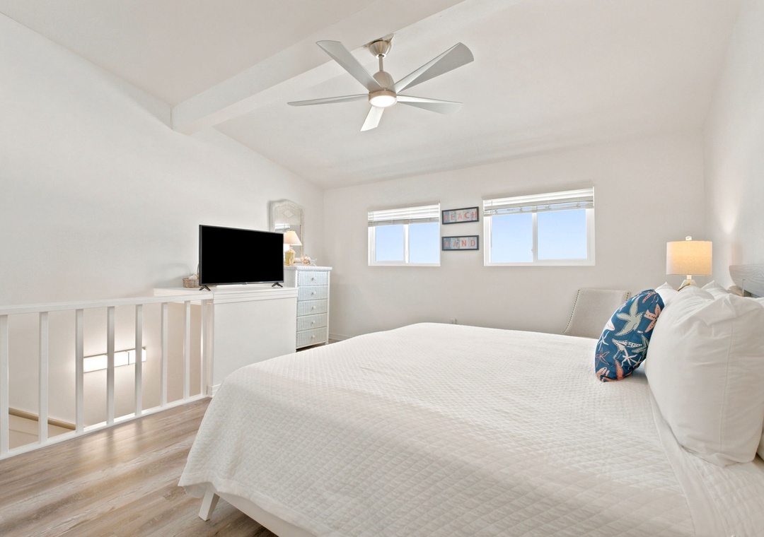 Gulfside Villas 2B- Drift into a peaceful slumber in this serene, light-filled bedroom, where a plush bed and airy coastal vibes invite you to unwind in complete comfort.