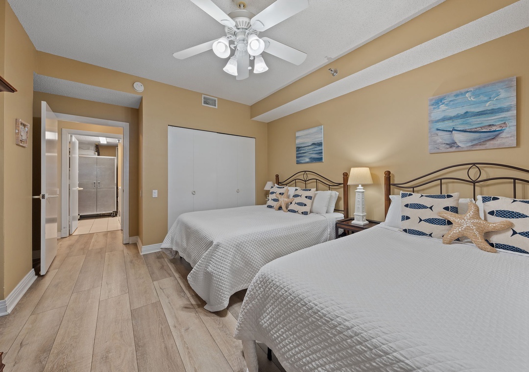 Beach Colony T15B- Drift off in a serene coastal retreat with two plush beds, nautical accents, and soothing ocean-inspired decor—your peaceful escape awaits.