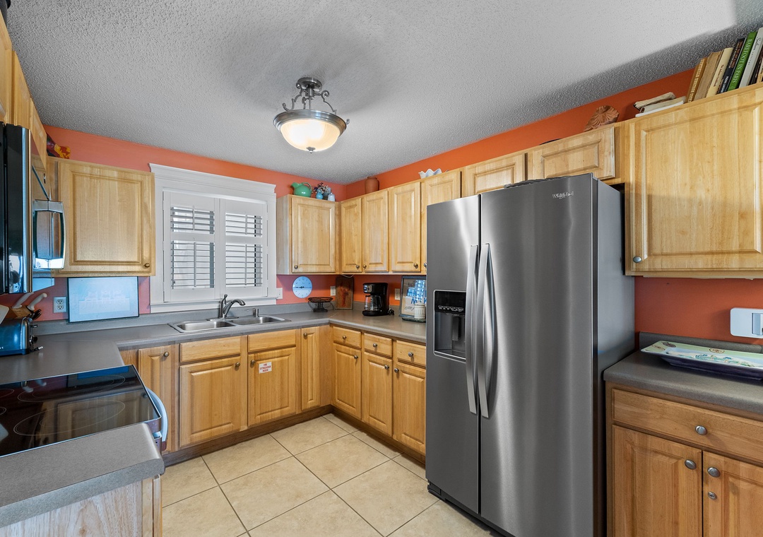 Sandy Key 338- Your fully equipped kitchen makes meal prep a breeze, with modern appliances, warm wood cabinetry, and plenty of counter space for cooking together.