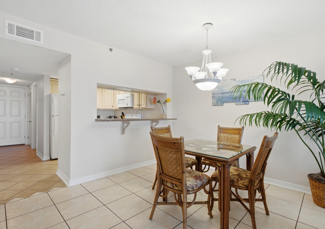 Ocean Breeze E702- Gather around the dining table for meals, with an open layout that flows seamlessly into the kitchen, brightened by natural light and tropical accents.