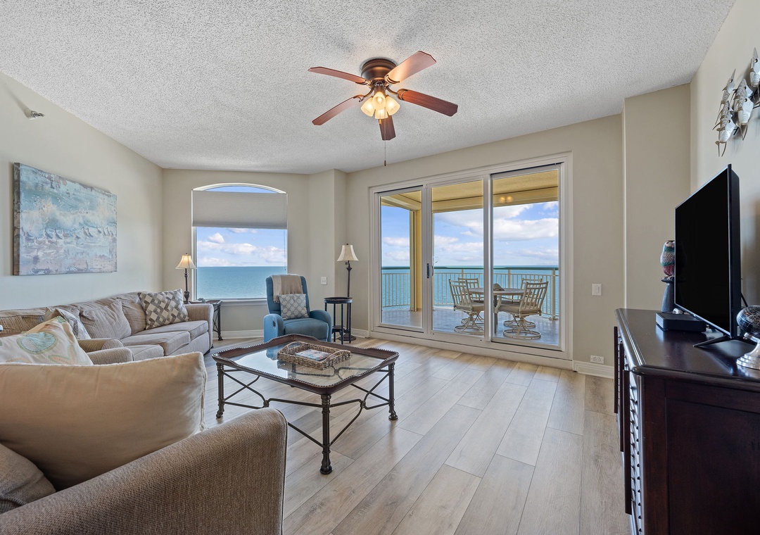 Beach Colony T15B- Unwind in your beautifully appointed living room where plush seating invites relaxation and stunning ocean views greet you through expansive glass doors leading to your private balcony.