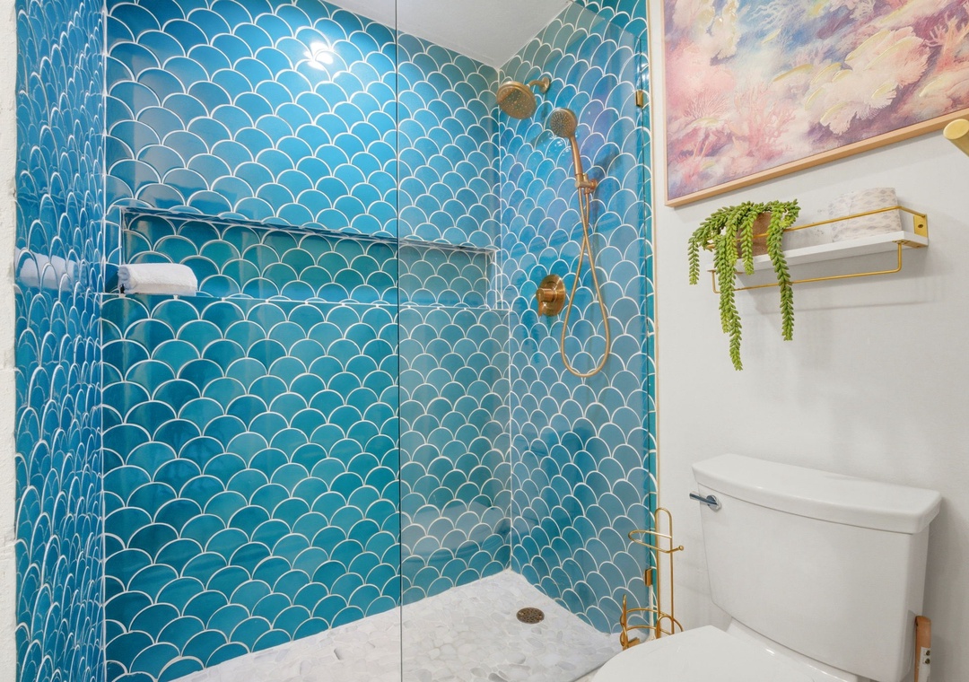 North Lost Key Landing B2- Refresh yourself in this spa-like bathroom, where stunning blue scallop tiles and gold fixtures create a vibrant, coastal-inspired retreat perfect for unwinding after your adventures.