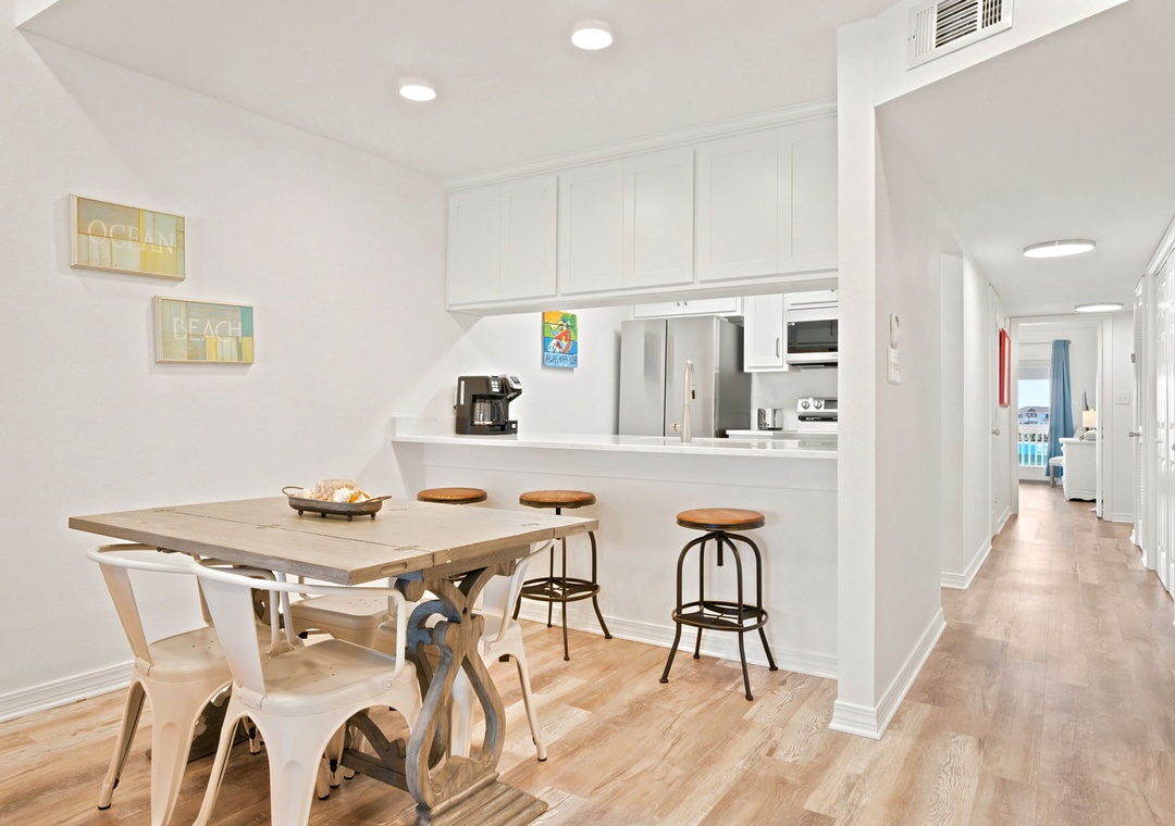 Gulfside Villas 2B- Gather around the dining table for meals, with the open kitchen just steps away. Bright, airy, and perfect for your morning coffee or evening plans.