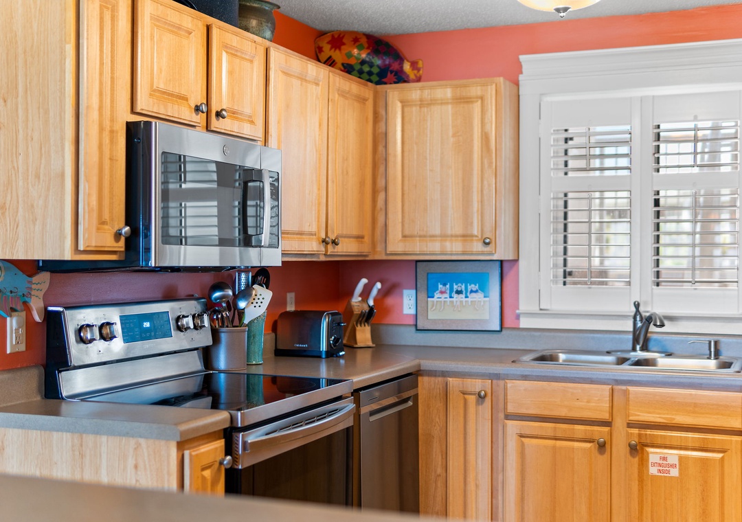 Sandy Key 338- Your fully equipped kitchen awaits with stainless steel appliances, ample counter space, and cheerful coral walls—perfect for whipping up vacation meals together.