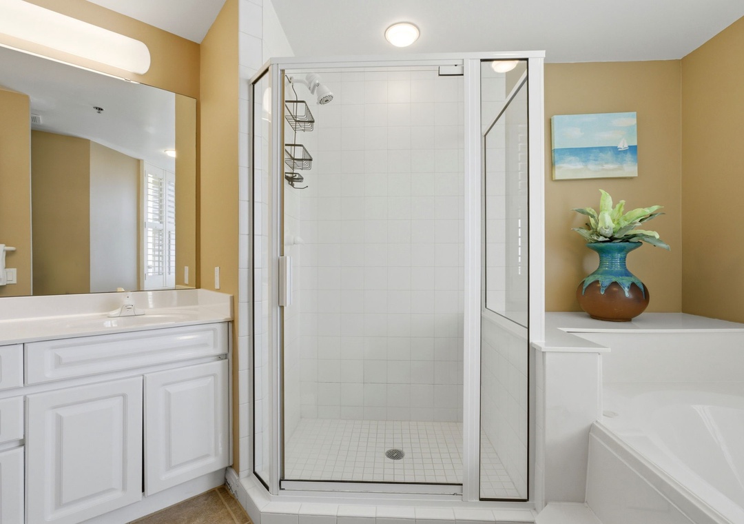 Beach Colony T PH1D- Unwind after a day of adventure in your private bathroom with a walk-in shower, separate soaking tub, and coastal-inspired décor that makes every refresh feel like a spa moment.