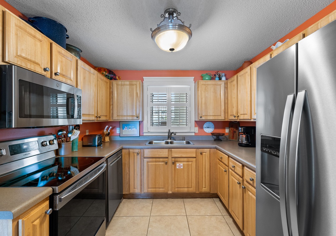 Sandy Key 338- Your fully equipped kitchen features stainless steel appliances, warm wood cabinetry, and plenty of counter space to prepare your favorite meals during your stay.
