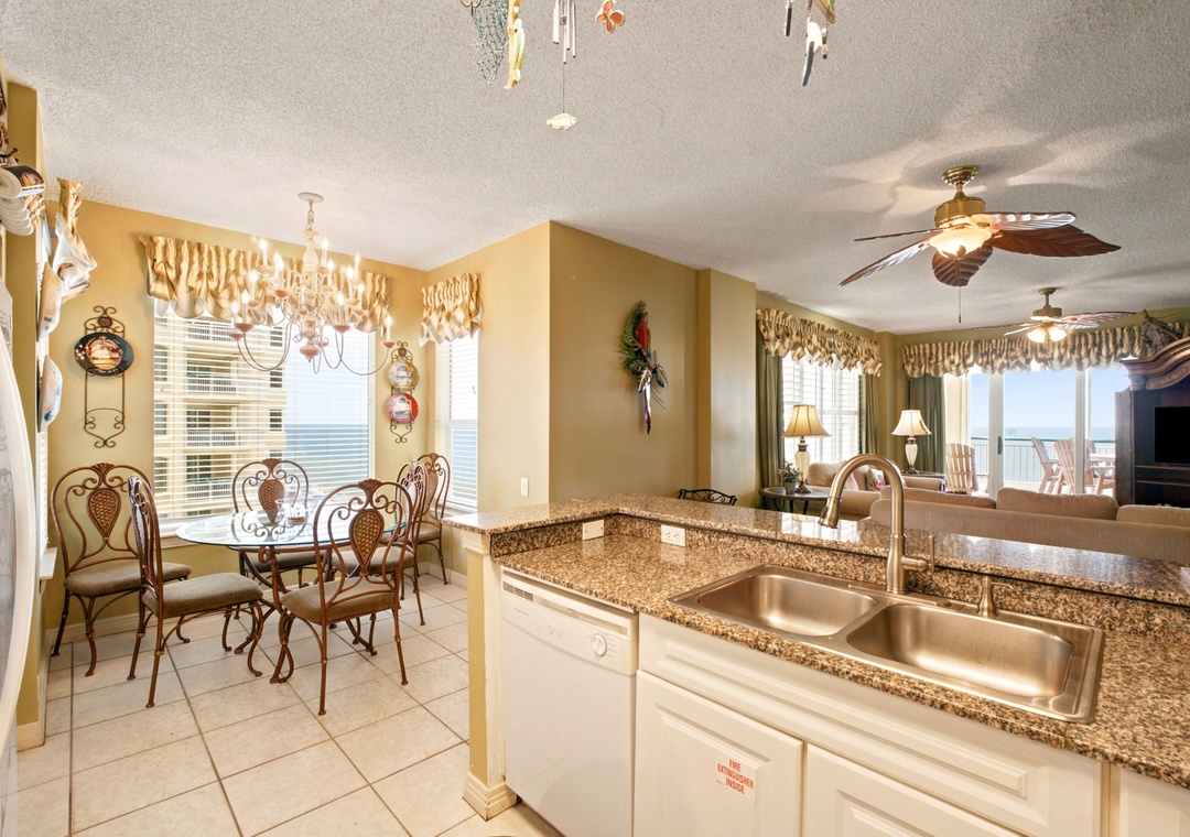 Beach Colony W13A- Your open-concept kitchen and dining area invite you to whip up meals and savor them together, all while enjoying bright Gulf views through every window.