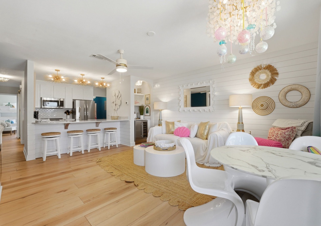 North Lost Key Landing B2- Step into your bright, coastal-chic retreat where airy whites meet golden accents. Relax on plush seating under a shimmering chandelier, gather at the marble dining table, or chat at the kitchen bar.