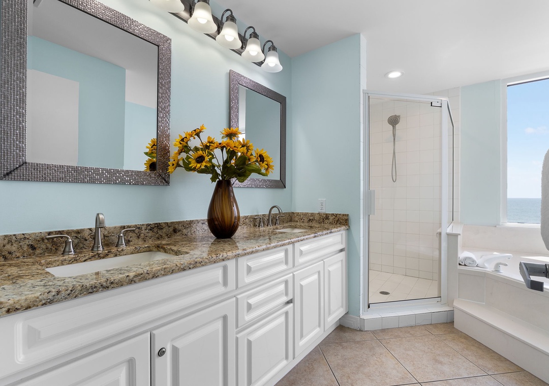 Beach Colony Tower 10C- Refresh in your spa-like bathroom with dual vanities, a granite countertop, a walk-in shower, and a soaking tub framed by stunning ocean views.