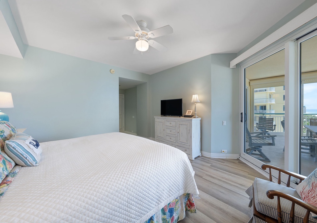 BCW6A Sink into a peaceful night's rest in this serene bedroom with calming coastal hues and easy balcony access to your private outdoor retreat.