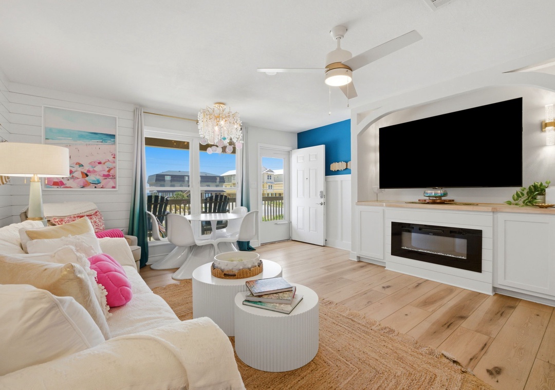 North Lost Key Landing B2- Relax in this bright, coastal-chic living space with a plush sofa, stylish décor, and a modern fireplace. Your private balcony overlooks the neighborhood, perfect for morning coffee or evening unwinding.