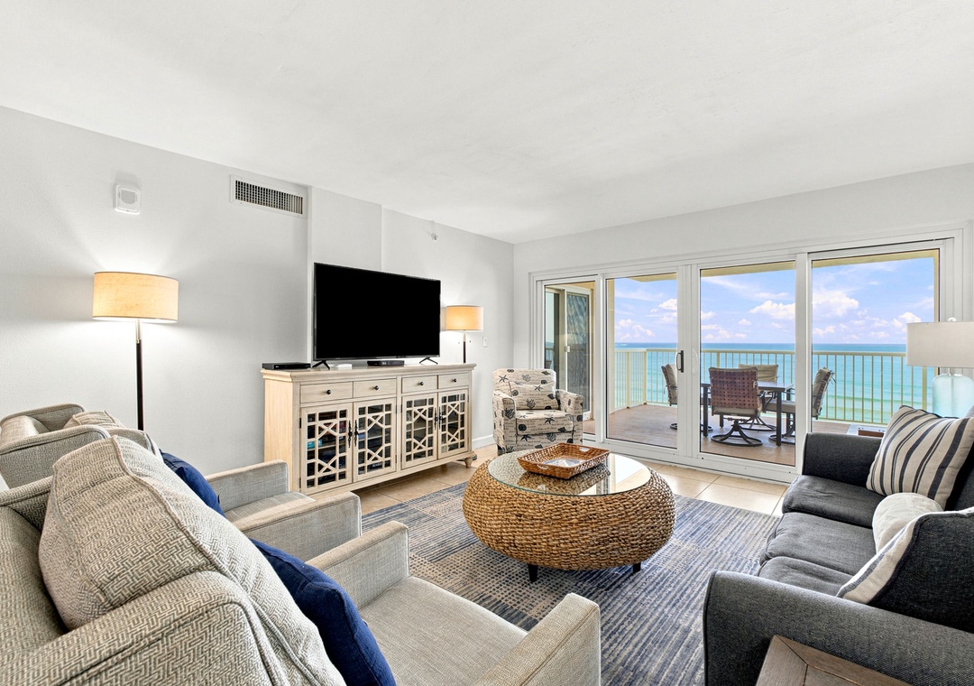 Sandy Key 411- Unwind in your bright living room with plush seating and floor-to-ceiling windows framing stunning turquoise waters. Step onto your private balcony to soak in the sea breeze and endless ocean views.