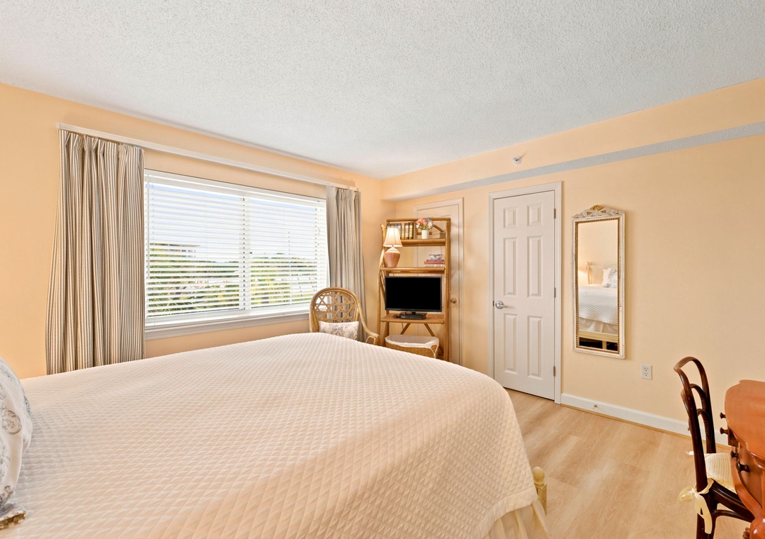 Sandy Key 338- Relax in this bright, cheerful bedroom featuring a plush queen bed, warm natural light, and a cozy TV nook—your perfect retreat after exploring the area.