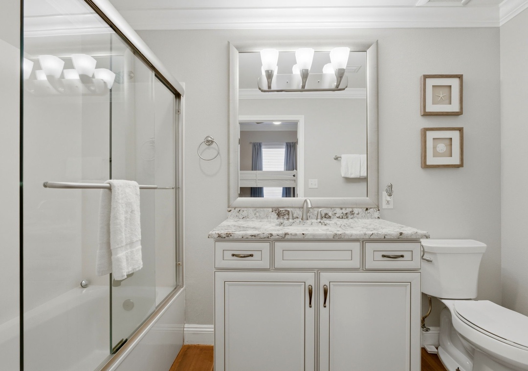 Freshly updated bathroom with gleaming granite countertops and a spacious walk-in shower, perfect for your morning refresh before a day of adventure.