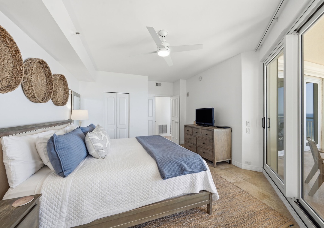 Beach Colony T14B- Drift off in this serene bedroom where coastal breezes greet you through your private balcony. Crisp whites and soft blues invite rest after sun-soaked days.
