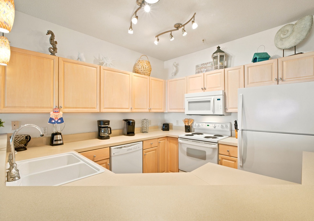 Step into your fully equipped kitchen, where coastal charm meets convenience. With ample counter space and all the appliances you need, preparing your favorite meals becomes a delightful part of your beach getaway.