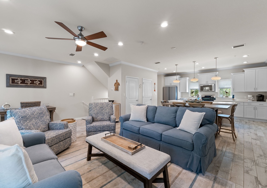 Turtles Nest- Step into your spacious open-concept retreat where plush seating and coastal-inspired tones invite you to unwind, while the modern kitchen stands ready for morning coffee or family meals together.