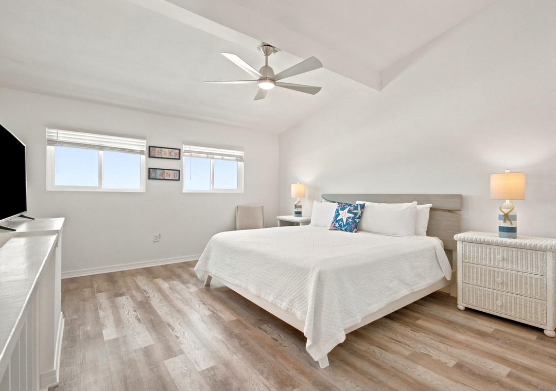 Gulfside Villas 2B- Drift off in your bright, serene bedroom with plush bedding, soothing coastal decor, and a ceiling fan keeping you cool and comfortable all night long.