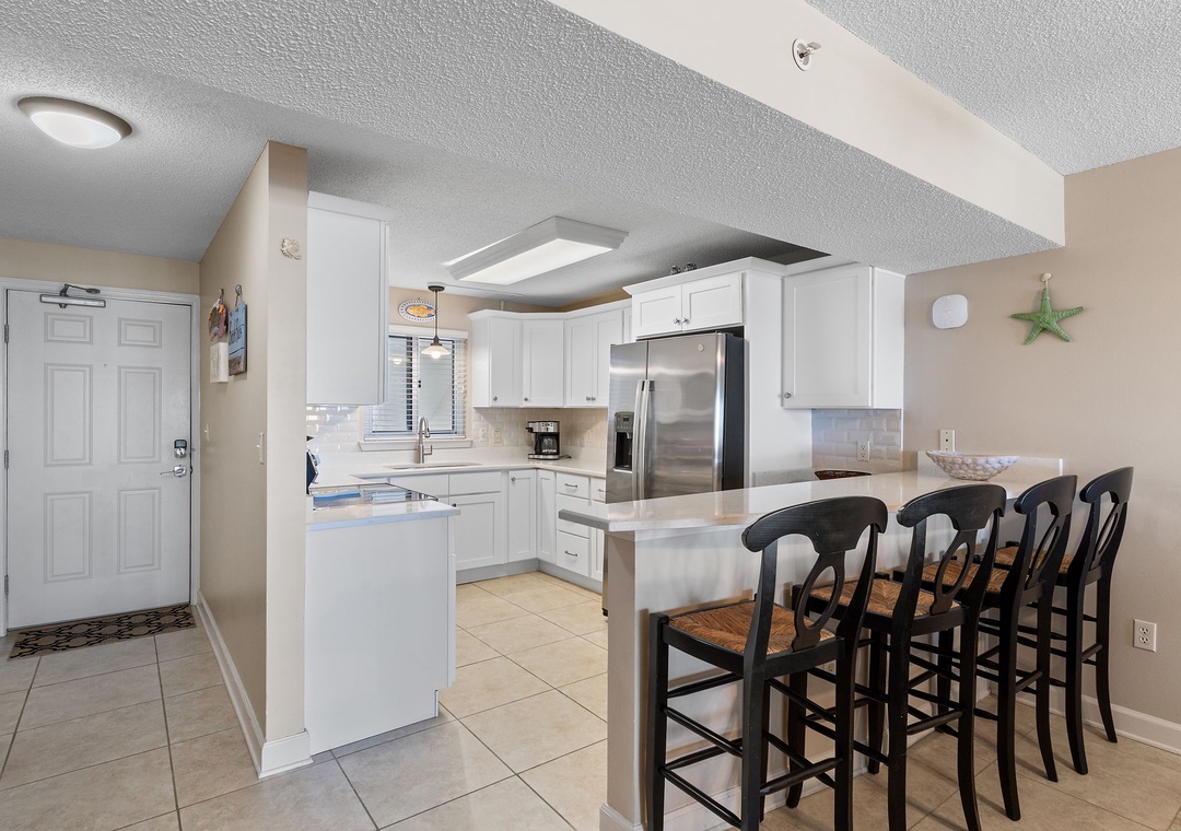 Sandy Key 628- Step into your bright, fully-equipped kitchen with crisp white cabinetry, stainless appliances, and a spacious breakfast bar perfect for morning coffee or casual meals with loved ones.