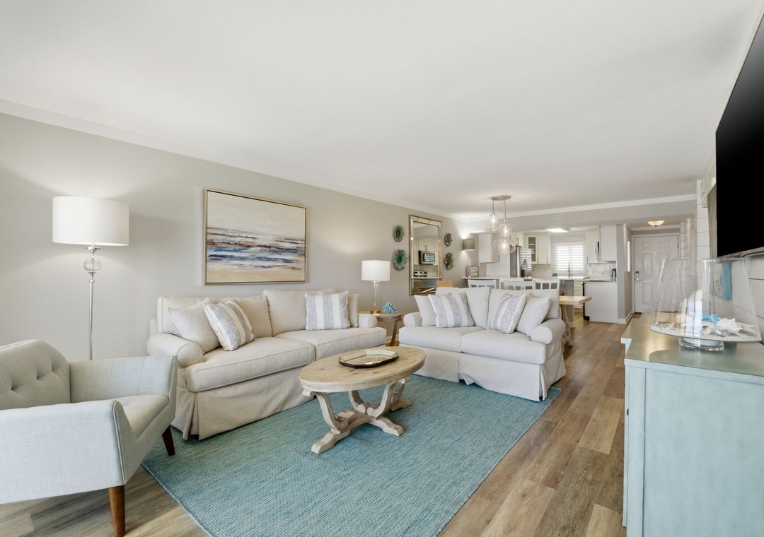 Sandy Key 827- Sink into soft sofas and unwind in your coastal-inspired living space, where natural light and serene colors create the perfect retreat after a day of exploring.